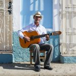 Cuba, Trinidad, portrait of man playing guitar on the street